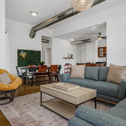 Living room with blue sectional sofa and hardwood floors