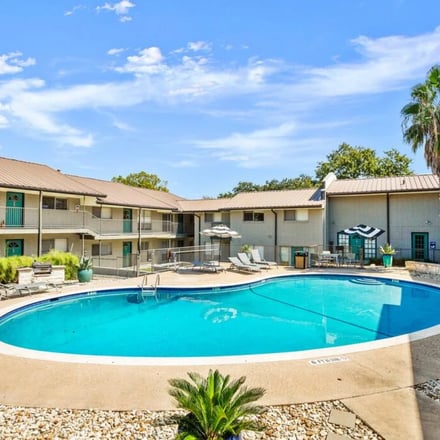 Outdoor pool with lounge chairs at an Austin Vacay property